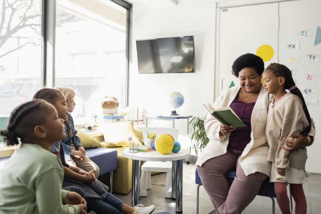 female teacher reading her pupils