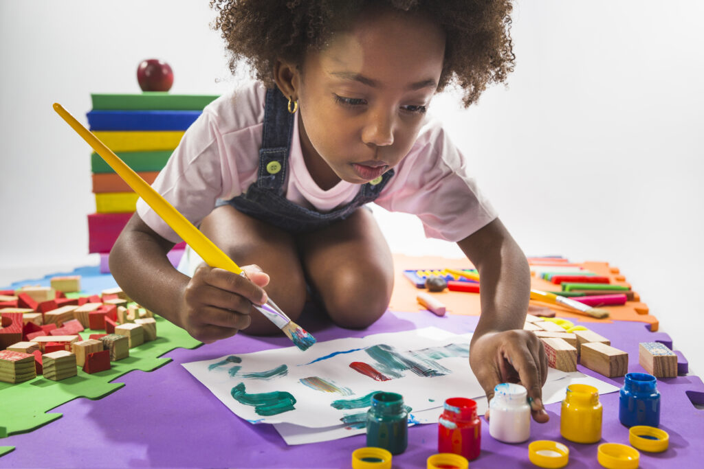 girl painting paper studio