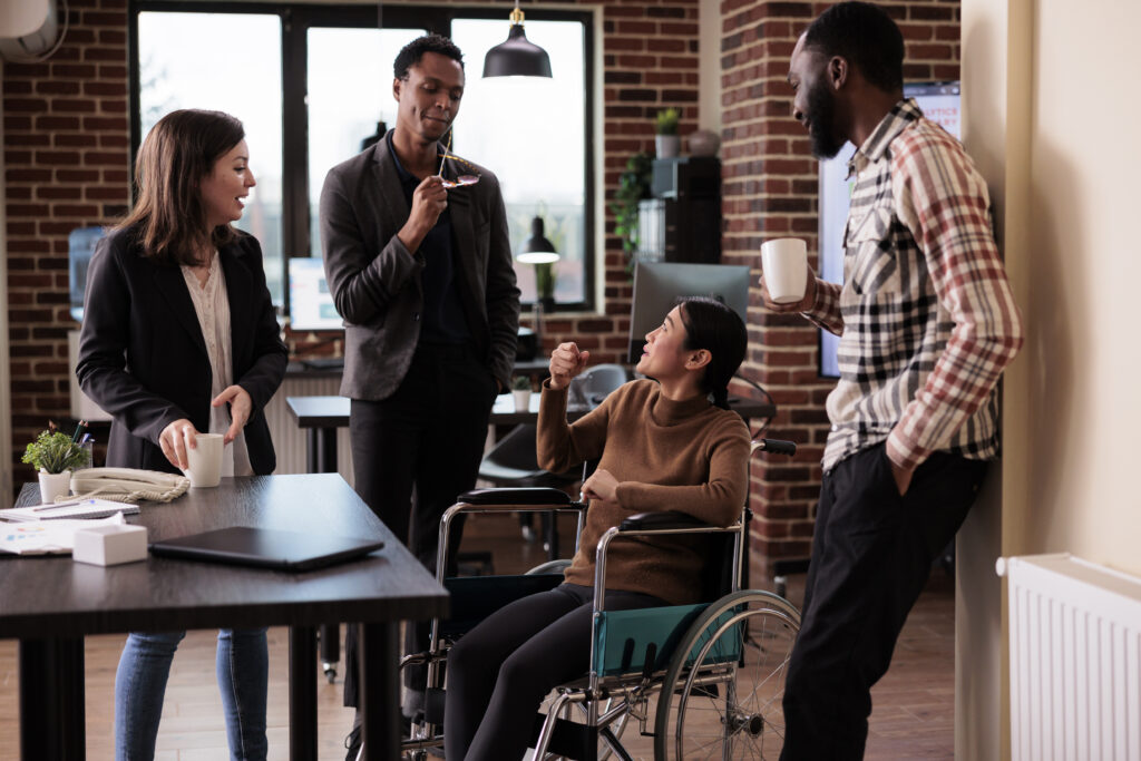 multiethnic group of colleagues laughing in business office