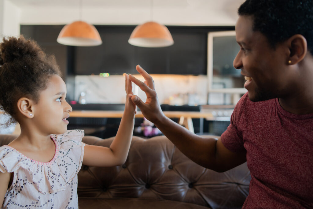 daughter and father playing together at home.