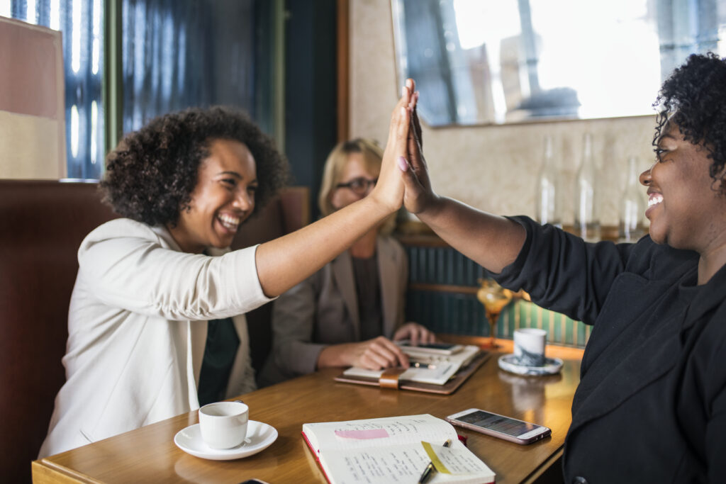 succesful businesswomen giving a high five